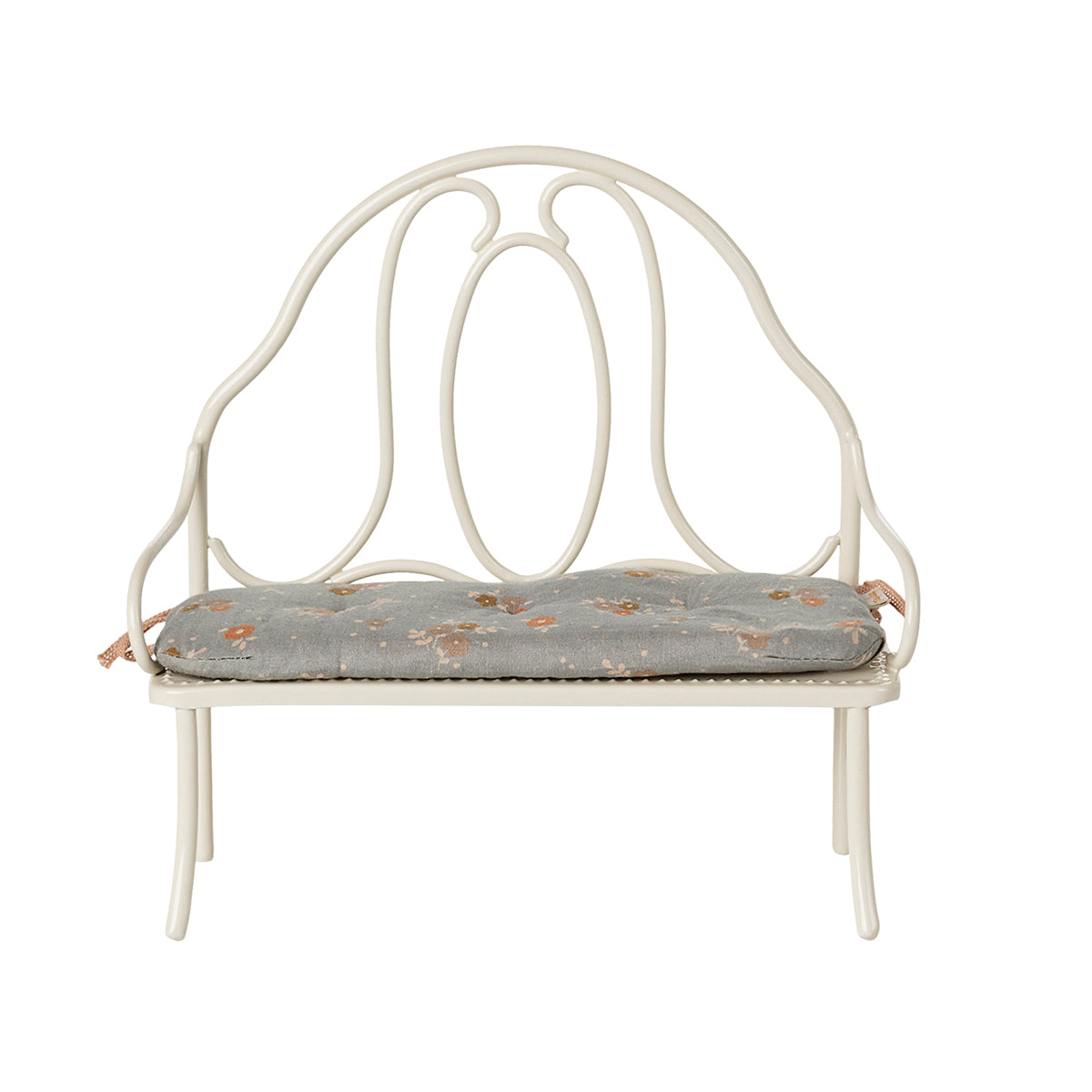 A front-facing view of the Maileg vintage-style bench in off white, highlighting its intricate metalwork and attached blue floral cushion.