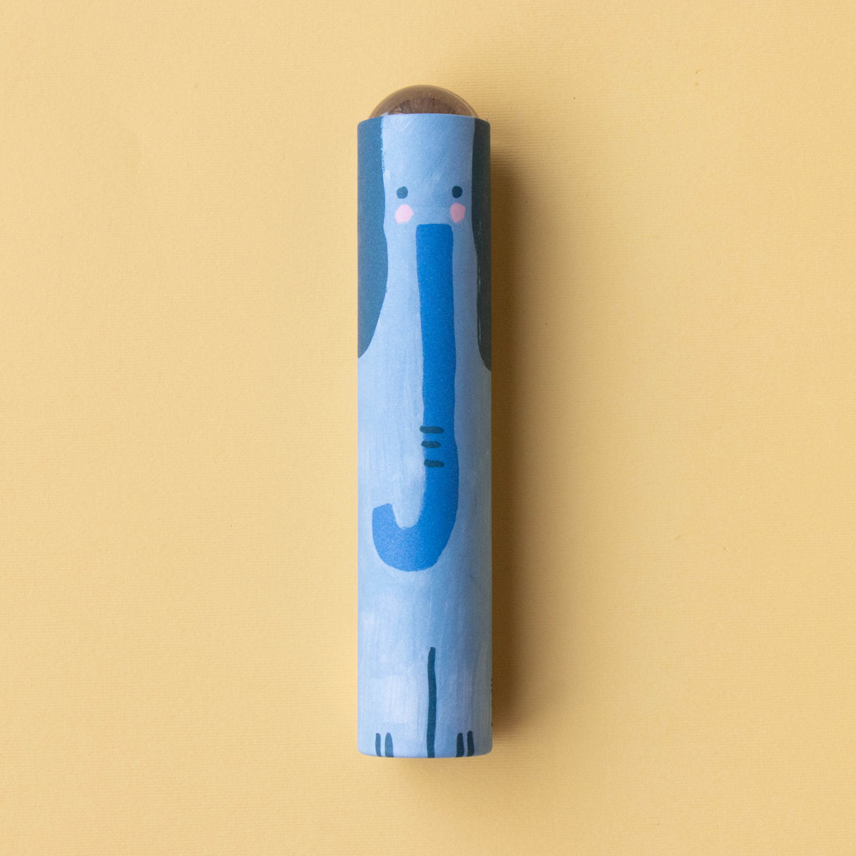 A close-up of a blue elephant-themed kaleidoscope with a friendly illustrated design on a yellow background.