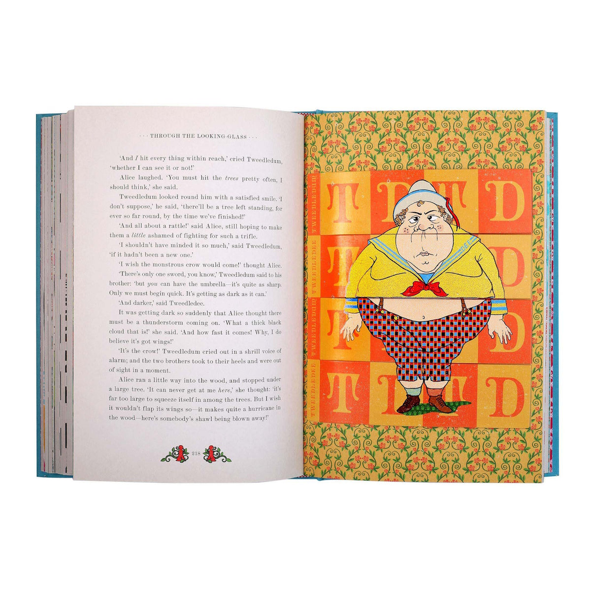 Open book featuring Alice in Wonderland text and a colorful pop-up illustration of Tweedledee in a checkered outfit.