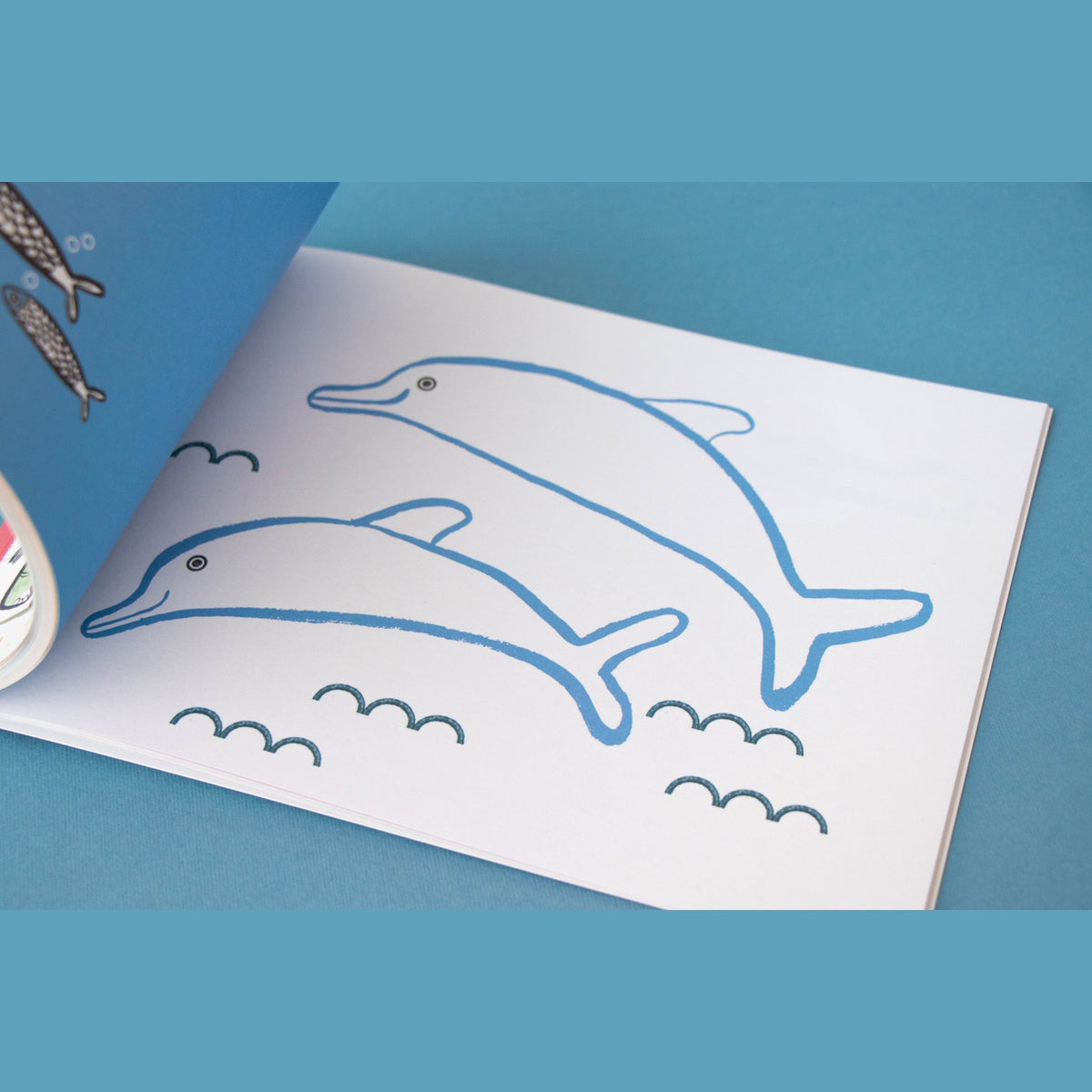 A Londji Art & Painting activity book page featuring two blue dolphin outlines for kids to color or paint.