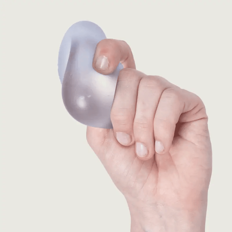 Hand squeezing a translucent lavender gel stress toy that squishes through fingers.