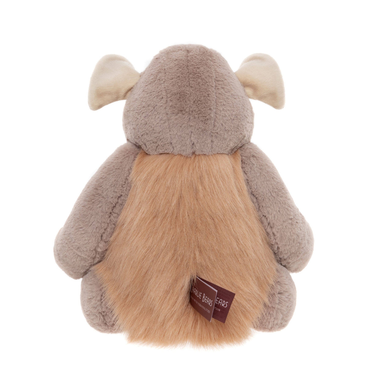 Back view of a soft grey plush monster toy showing light brown fluffy fur along its back and a brand tag.