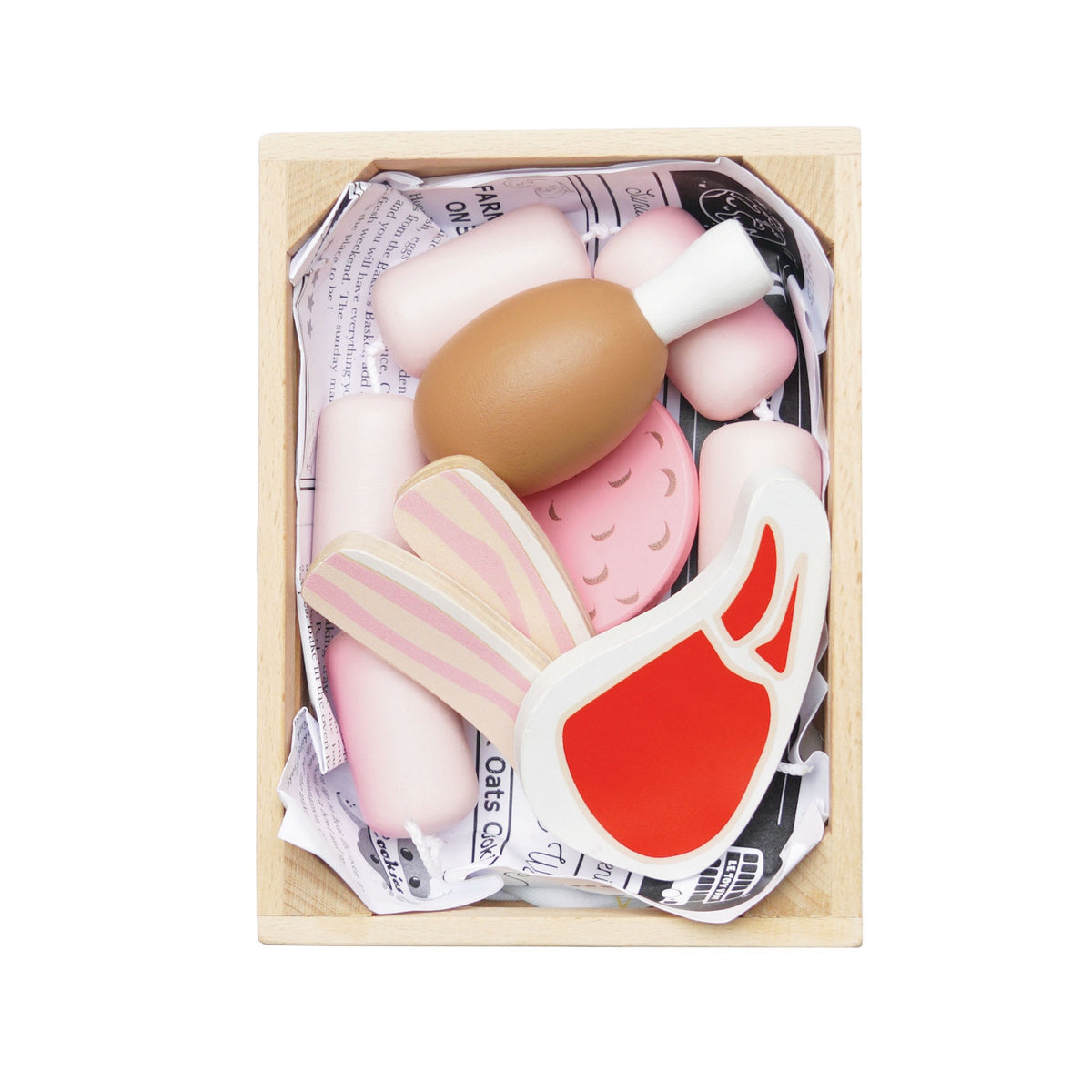 Top-down view of a wooden crate packed with play food meats and sausages.