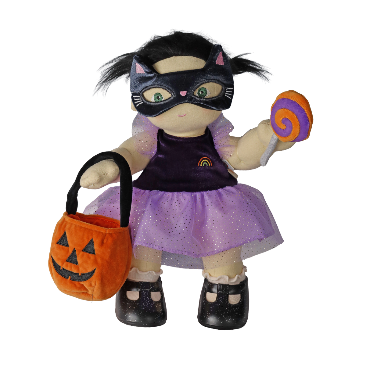 Plush doll wearing a cat mask, holding a pumpkin bag and plush lollipop against a white background.