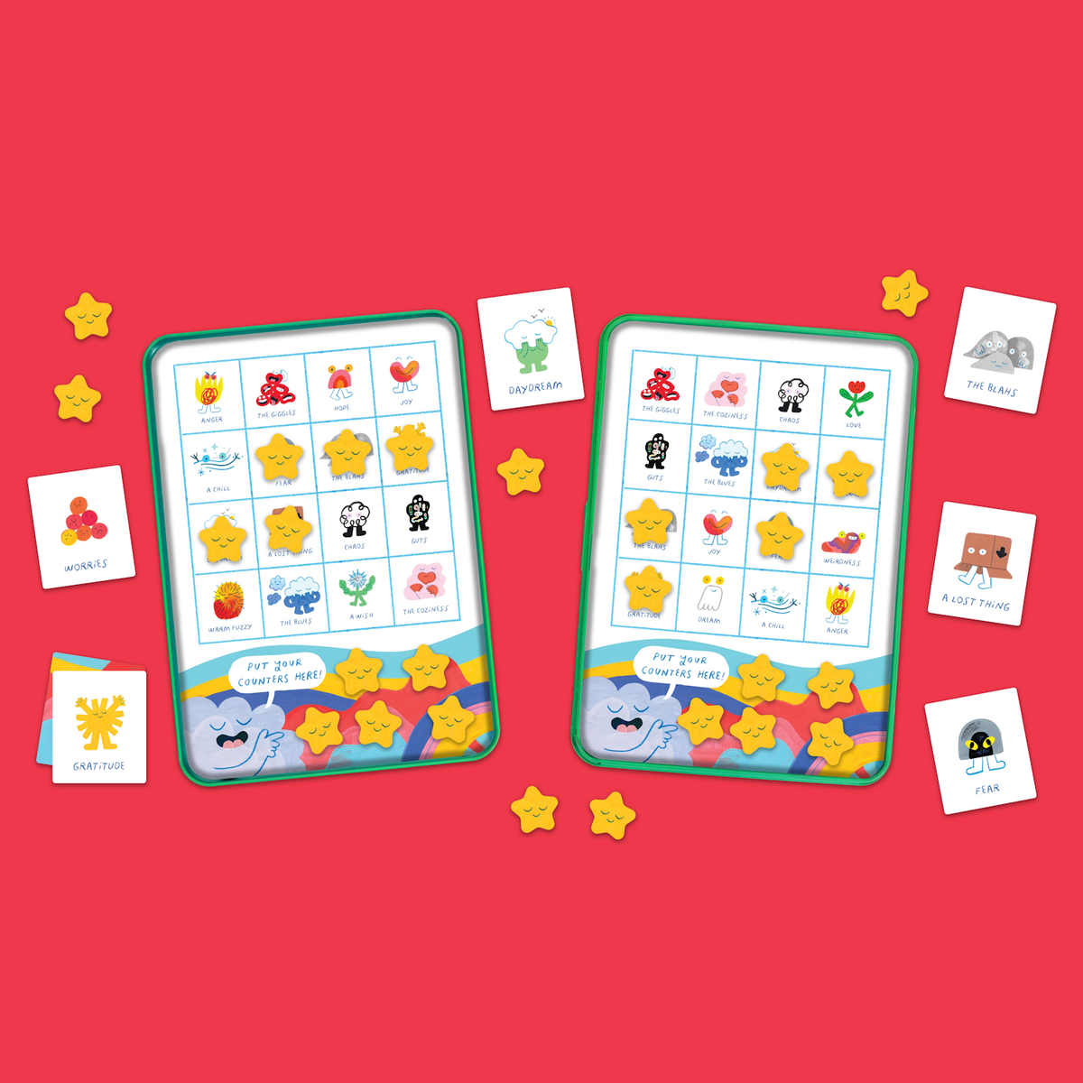 Two colorful game boards with cartoon emotions and pictures, scattered star-shaped tokens, and emotion cards on a red background, creating a playful and cheerful mood.