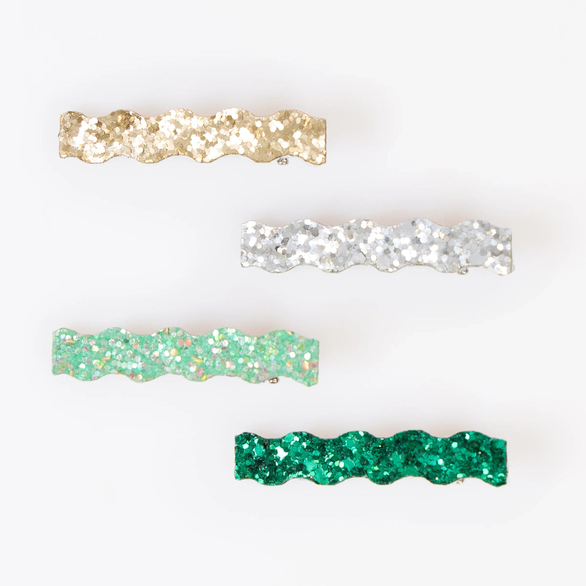 Four wavy glitter hair clips in gold, silver, mint, and dark green on a white backdrop.