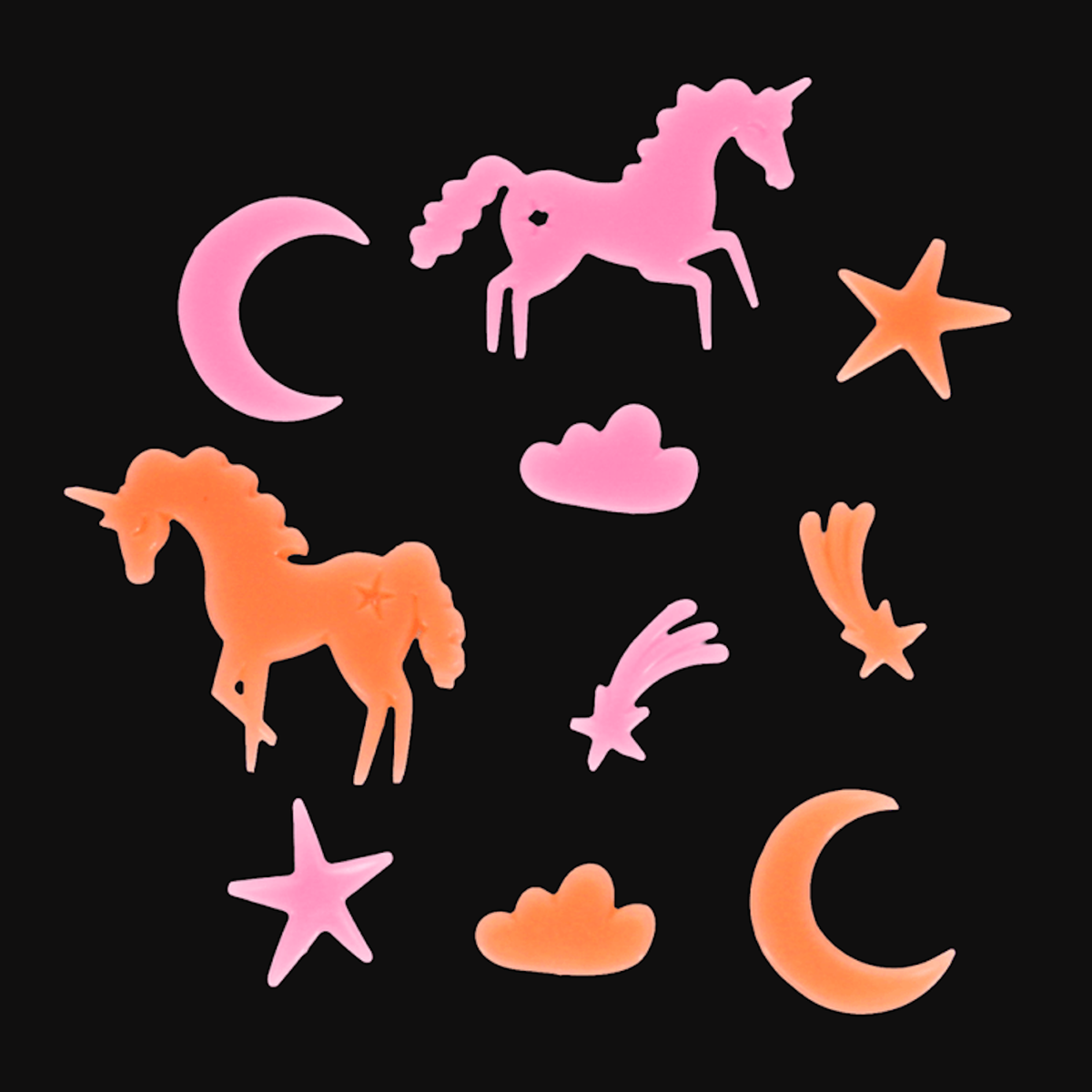 Pink and orange glow-in-the-dark plastic unicorns, stars, and crescent moons against a white background.