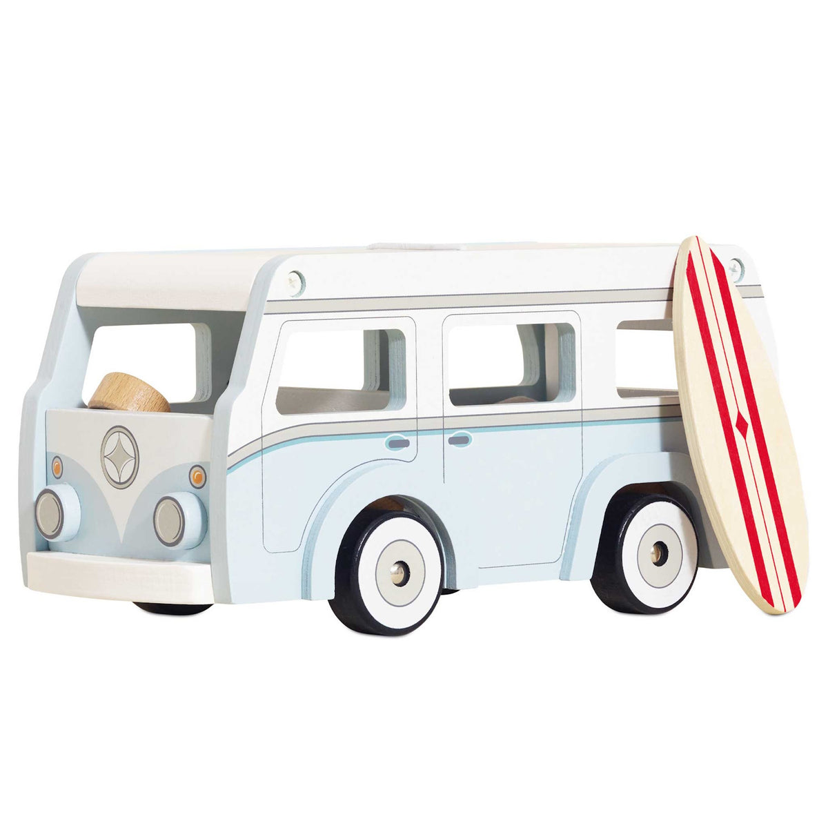 Light blue and white wooden toy camper van with a surf board leaning on its side.
