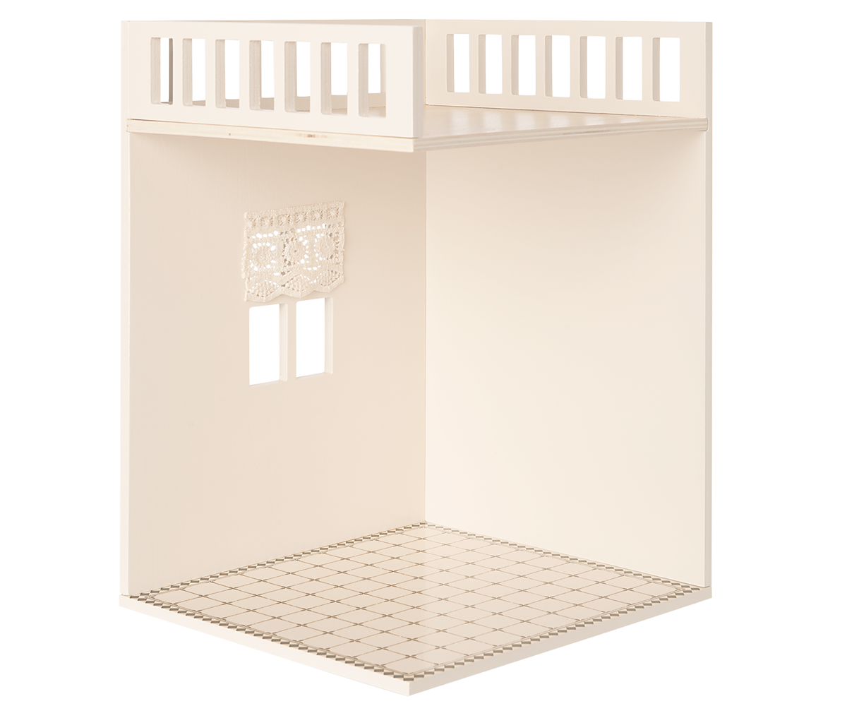 A minimalist dollhouse bathroom with two small windows and curtains, featuring a decorated tiled floor.