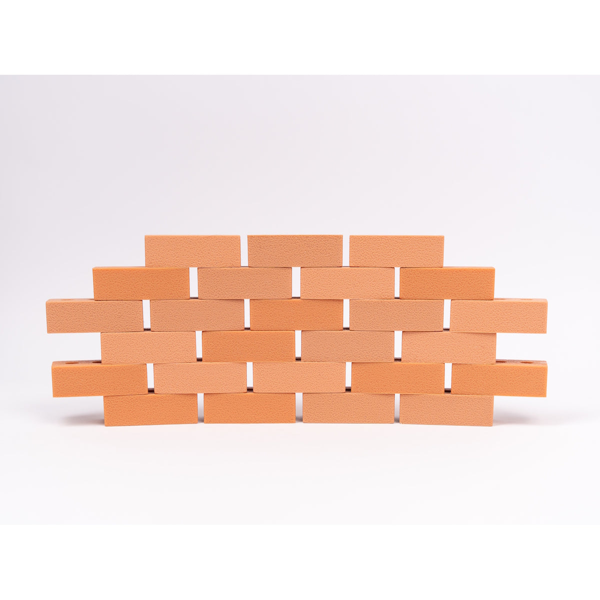 Silicone mini bricks, each brick is terracotta-colored with round holes, conveying a playful tone.
