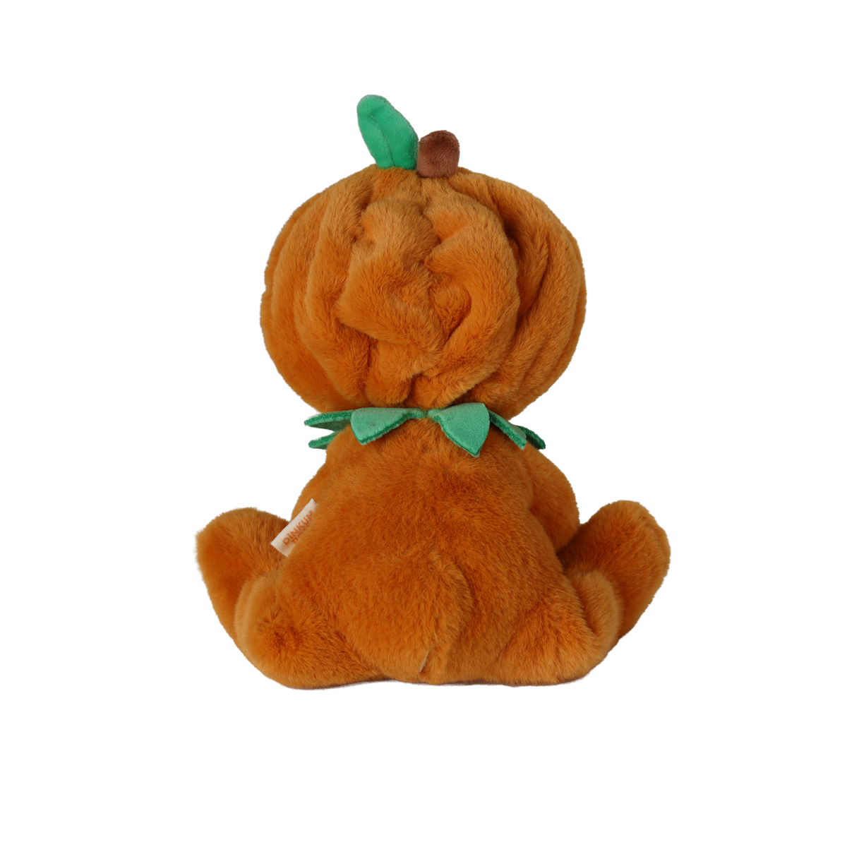 Back view of a seated plush doll in an orange pumpkin suit with a green leaf and stem on its hood.