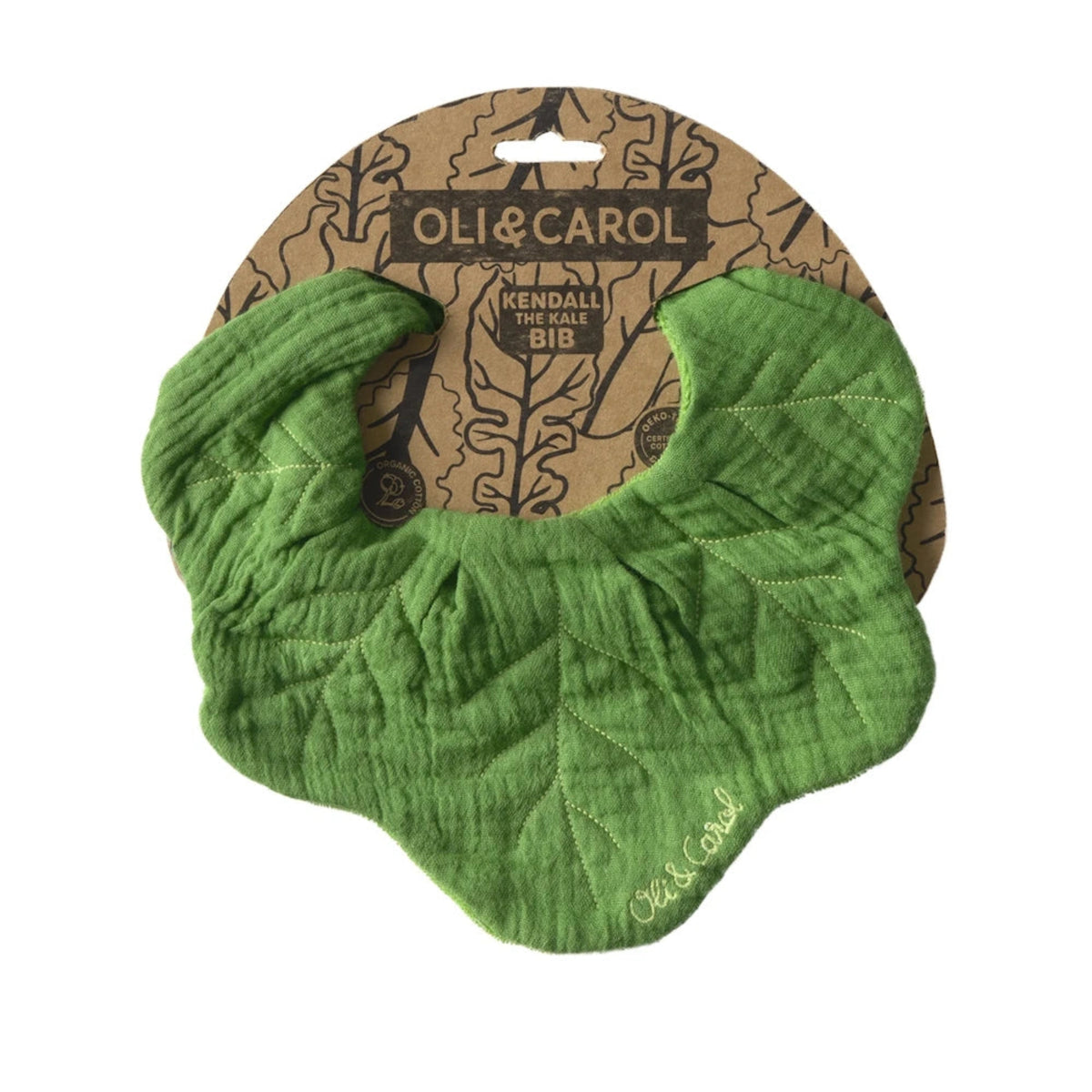 Oli & Carol Kendall the Kale baby bib, a green leaf-shaped muslin cotton bib on cardboard packaging.