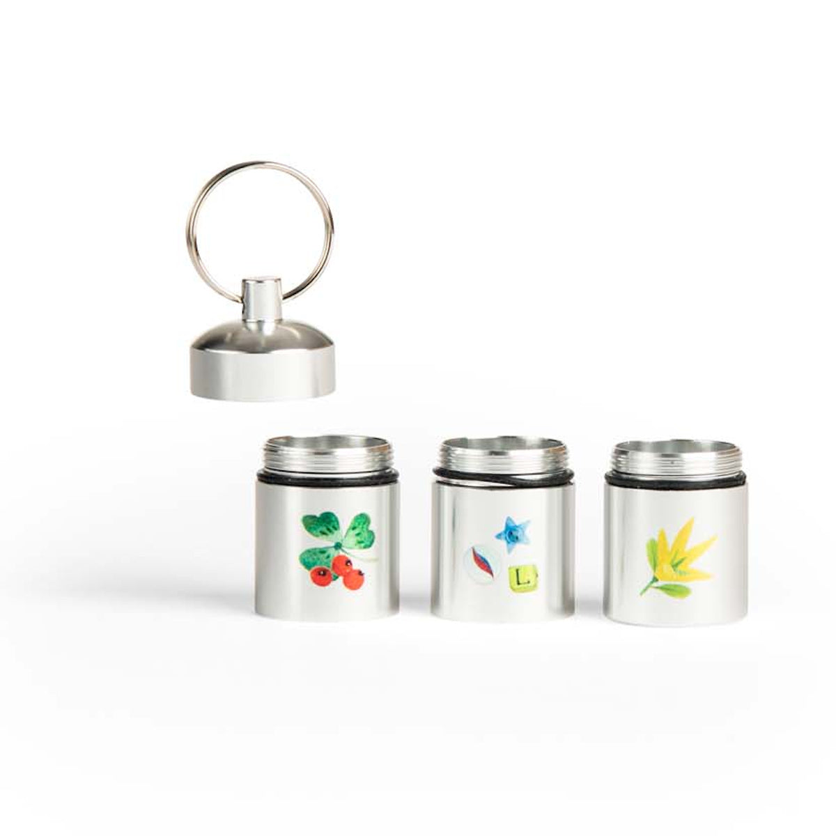 Moulin Roty Le Jardin du Moulin set of 3 silver metal treasure capsule containers with botanical nature illustrations.