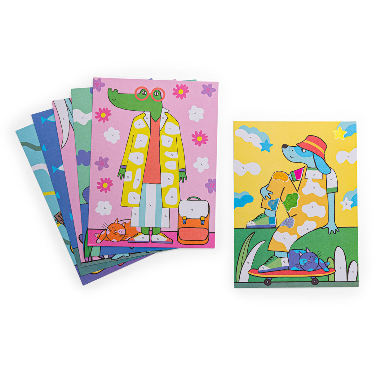 Colorful whimsical art cards featuring a dressed crocodile and a dog on a skateboard with cats and floral patterns.