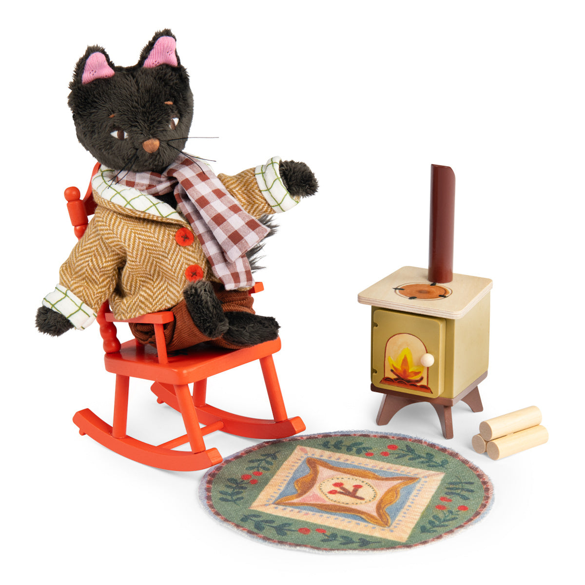 Plush black cat doll in a jacket sitting on a red rocking chair next to a toy fireplace heater and rug.
