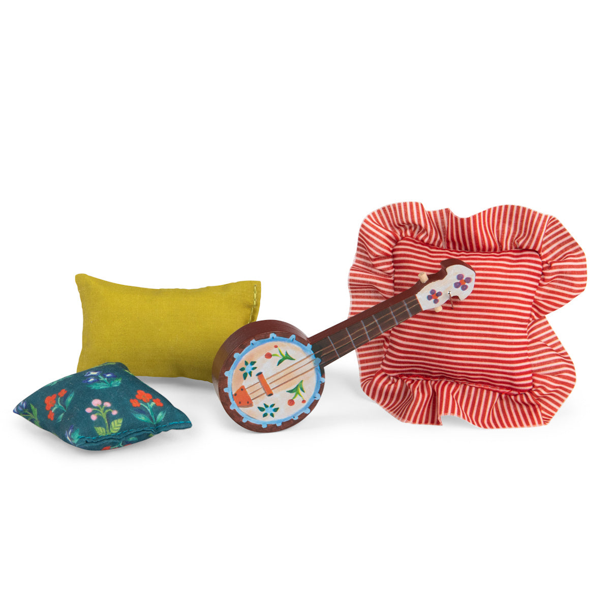 Les Minouchkas fireside accessories with a miniature toy banjo and three small colorful cushions.
