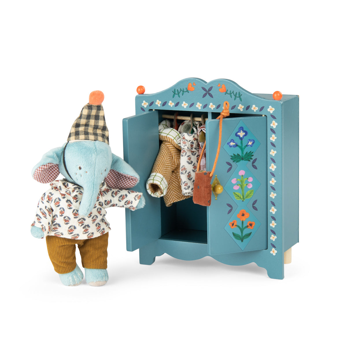 Plush elephant doll next to a blue wooden toy wardrobe filled with doll clothes.