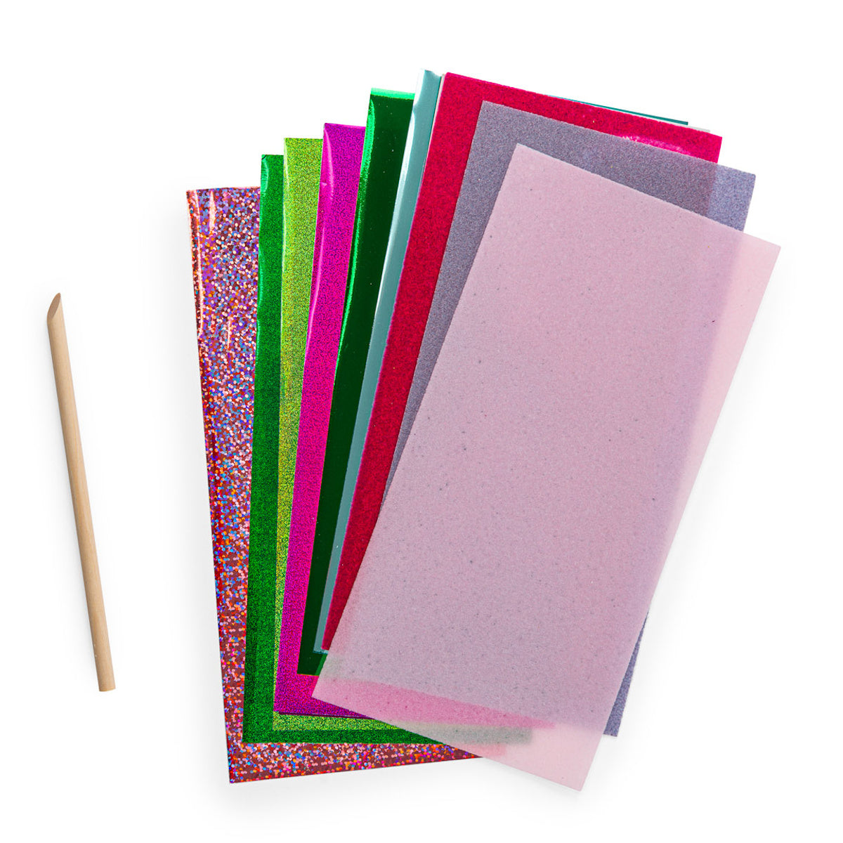 Colorful metallic foil sheets and tracing paper with a wooden stylus tool for crafts.