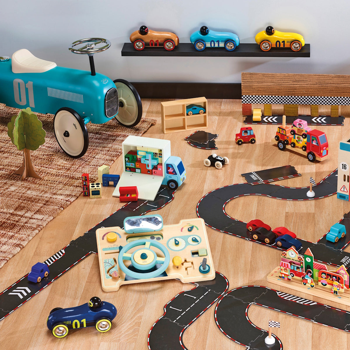 Wooden toy car set with race track, play dashboard, and ride-on car on a wooden floor.