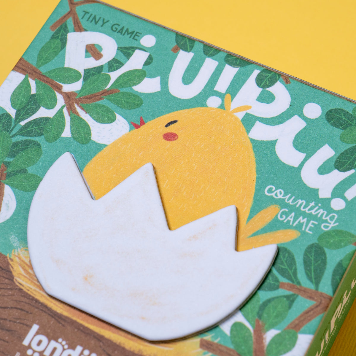 Londji Piu Piu counting game box featuring a yellow chick in an eggshell on a green leafy background.