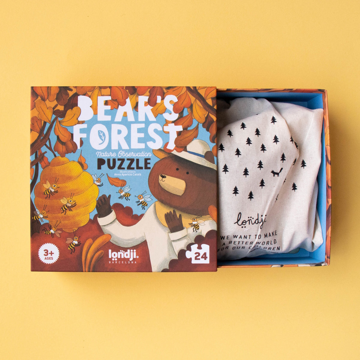 Londji Bear's Forest 24-piece puzzle box open to reveal a sustainable cotton bag for storing puzzle pieces.