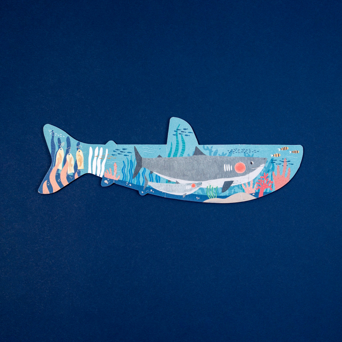 Londji shark-shaped puzzle for kids with detailed underwater coral reef illustration on a navy blue background.