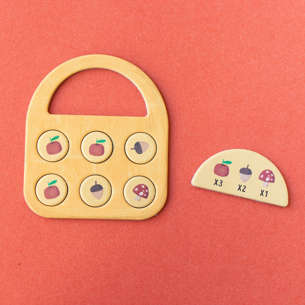 Londji Strawberries Tiny Game featuring a wooden basket board, scoring tokens, and forest-themed game pieces.