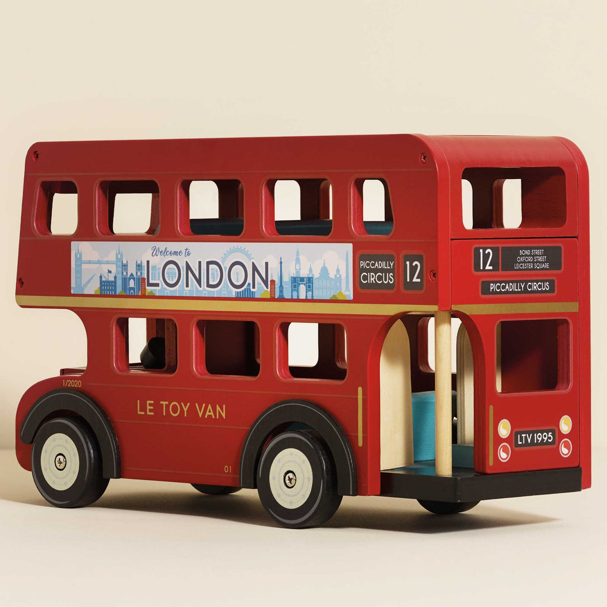 Red double-decker wooden London toy bus with route details and city skyline banner.