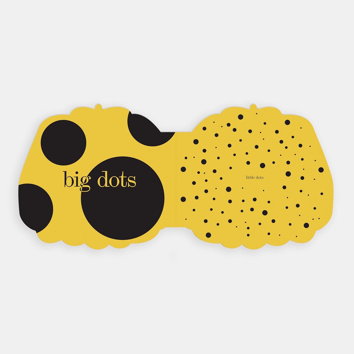 Shaped board book spread showing "big dots" on yellow opposite a scattered array of "little dots".