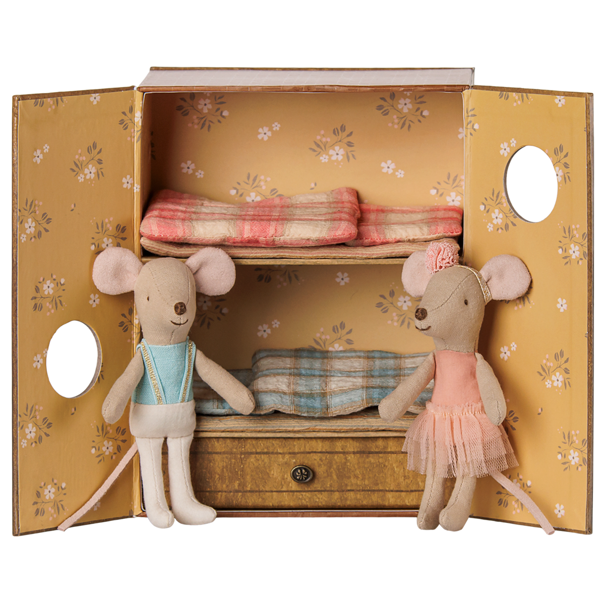 Two fabric toy mice inside a floral bunk bed box, one in a blue vest and one in a pink ballet tutu.