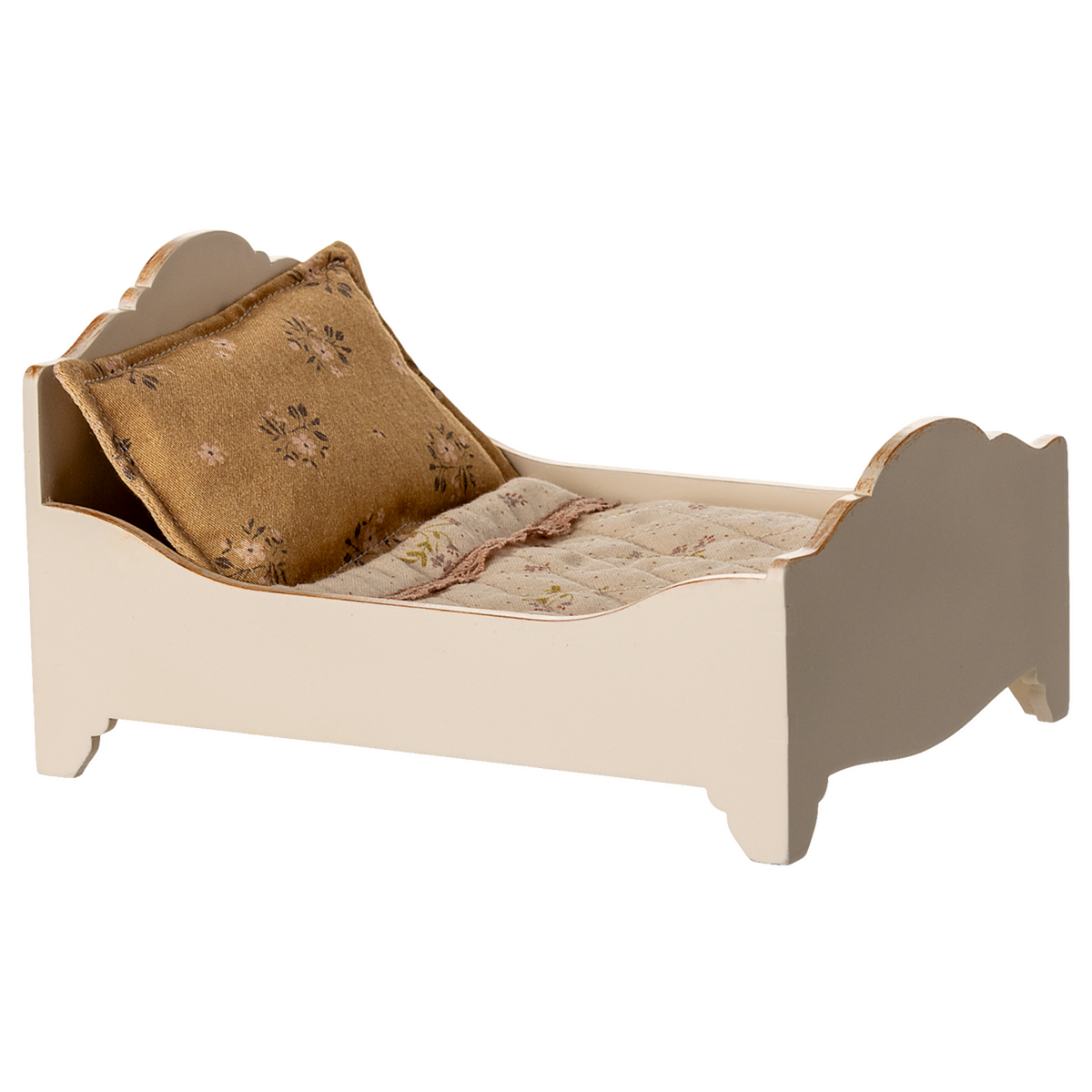 A vintage-style miniature bed with a quilted mattress and a decorative gold pillow, showcasing a charming rustic design in a white background.