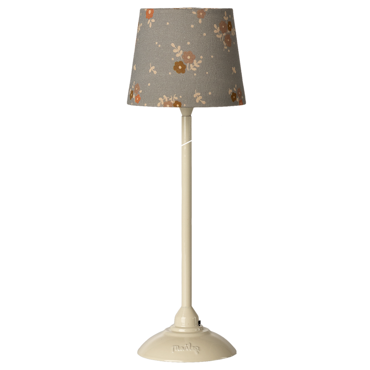 A tall ivory lamp with a gray floral-patterned shade stands against a white background. The lamp has a sleek design, exuding a modern vintage elegance.