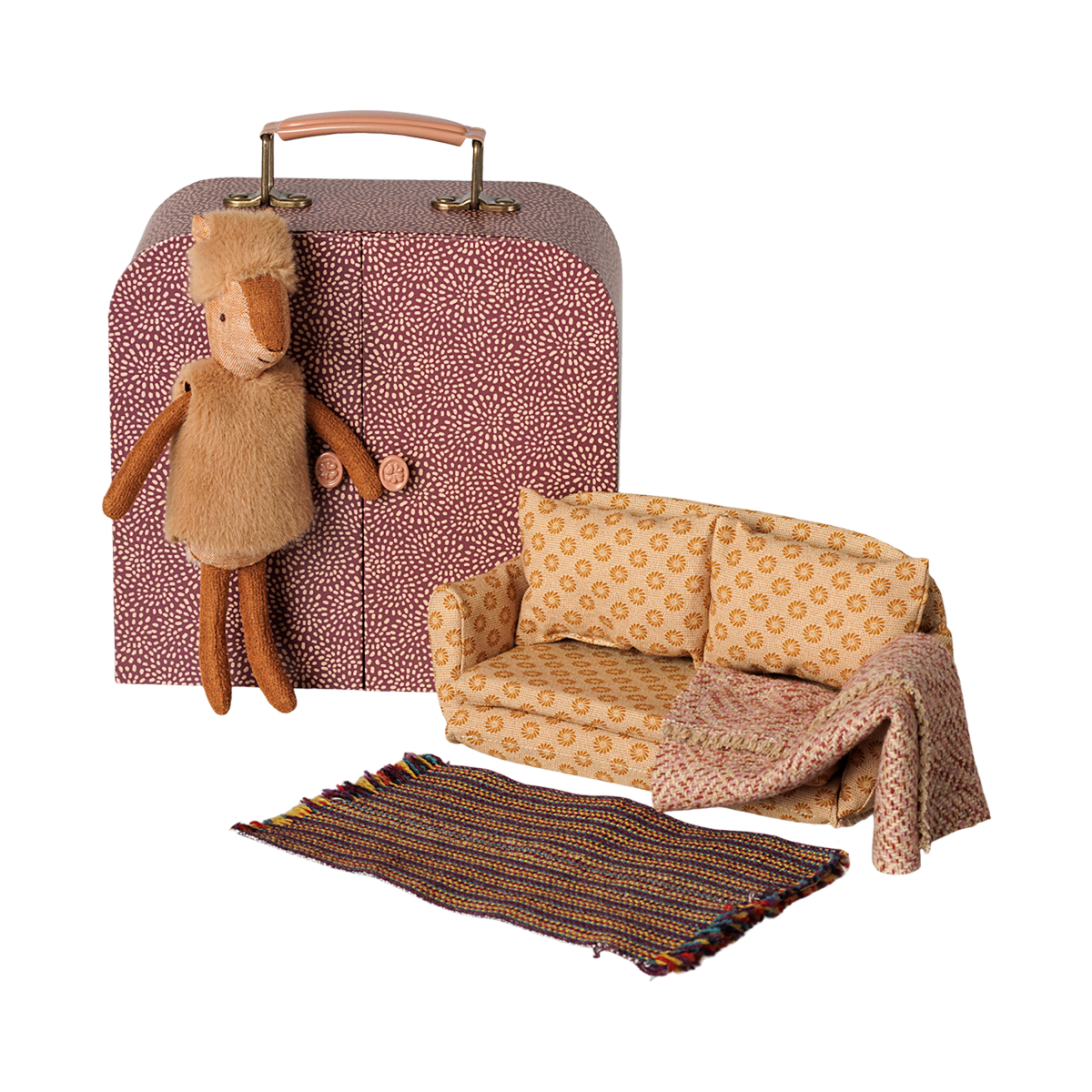 Maileg little sister reindeer doll with a miniature patterned suitcase wardrobe, couch, and rug.