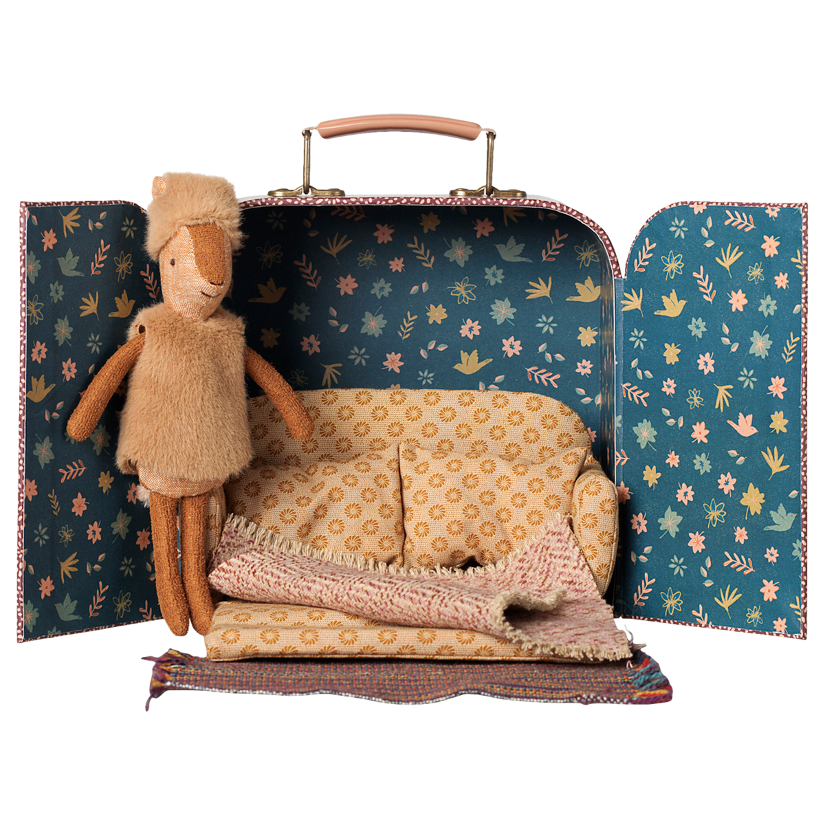 Maileg little sister reindeer plush doll inside a toy suitcase dollhouse with a miniature sofa.