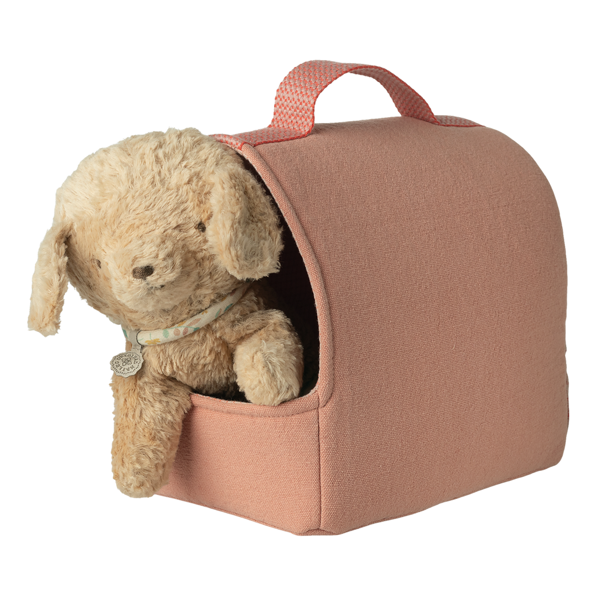 A plush teddy bear peeks from a cozy, pink fabric carrier with a handle, set against a white background, conveying warmth and comfort.
