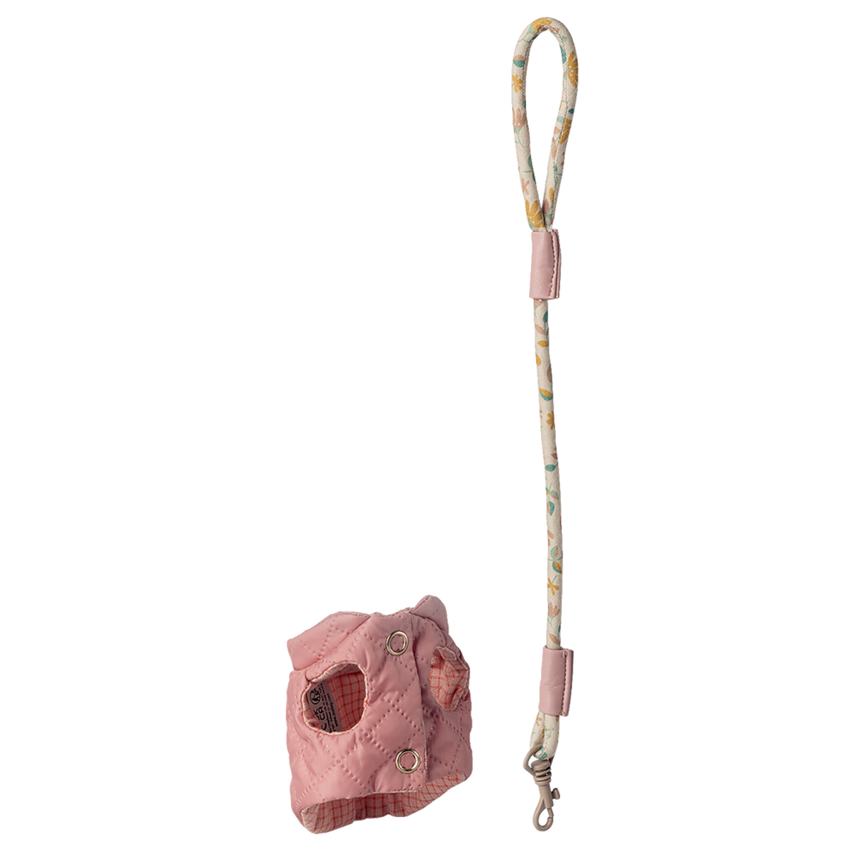Pink quilted dog harness with a patterned leash featuring floral designs, set against a white background. The design is playful and stylish.