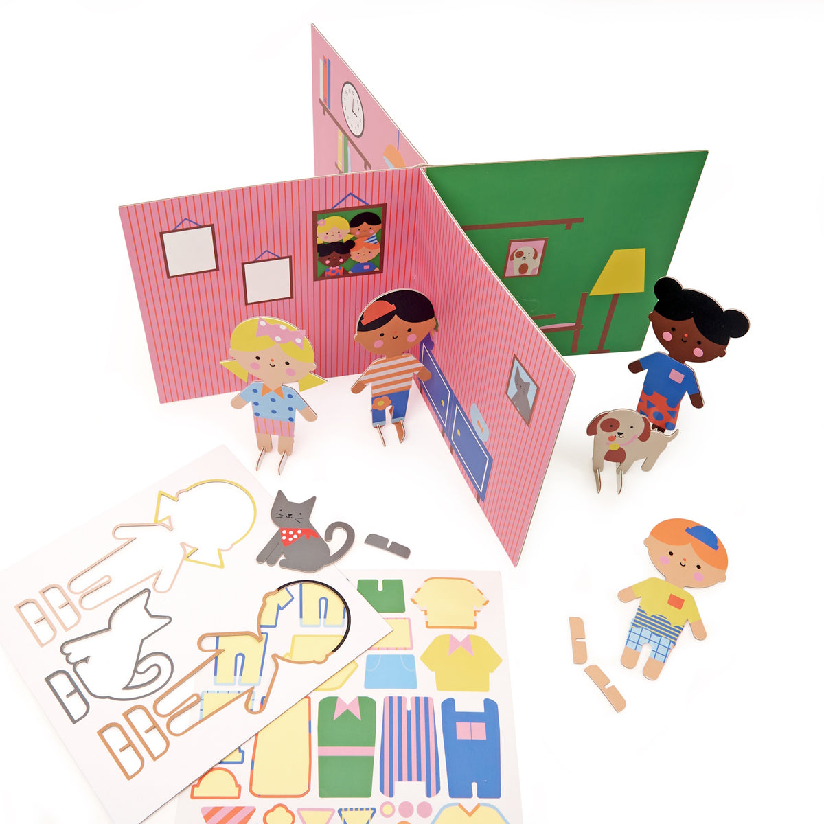 Opened 3D pop-up playhouse with character figures, a dog, and sticker sheets with outfit cutouts.