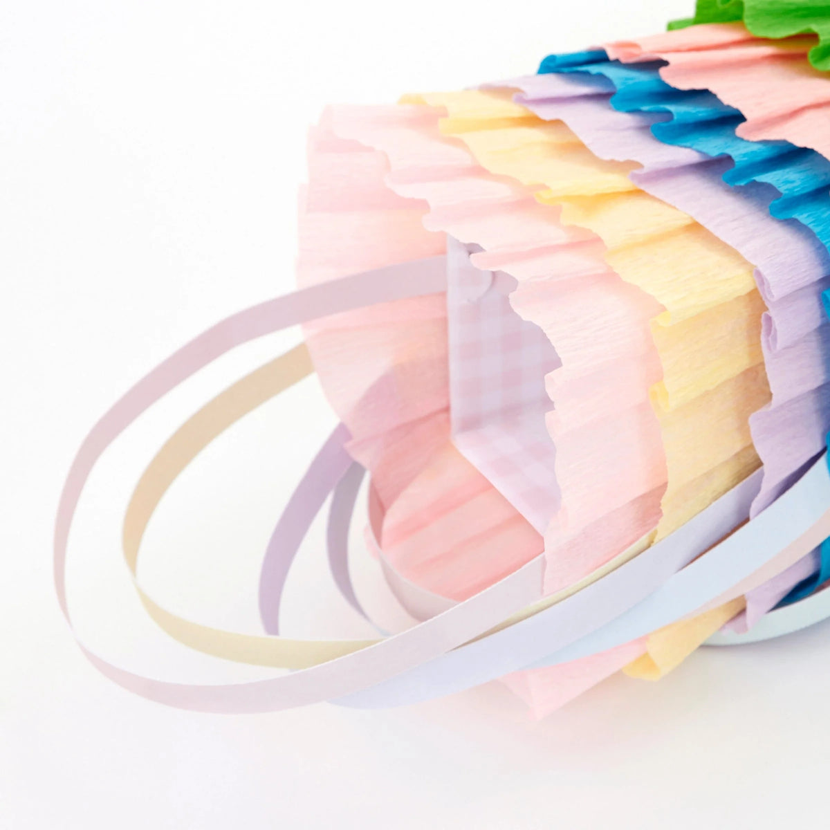 Pastel ruffled crepe paper Easter baskets with handles and gingham lining, perfect for spring party favors and gifts.