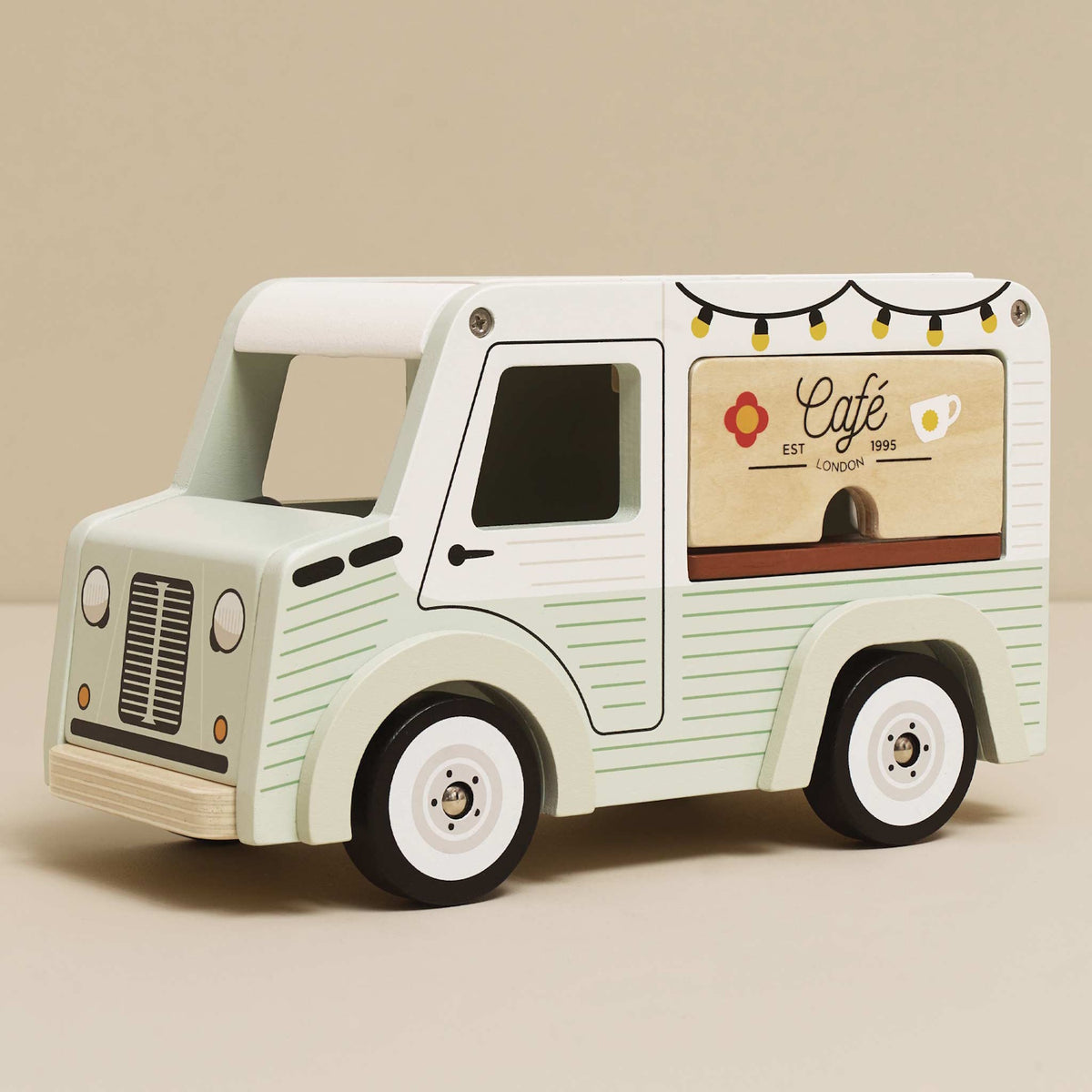 Vintage-style light green and white wooden toy cafe van with a serving counter.