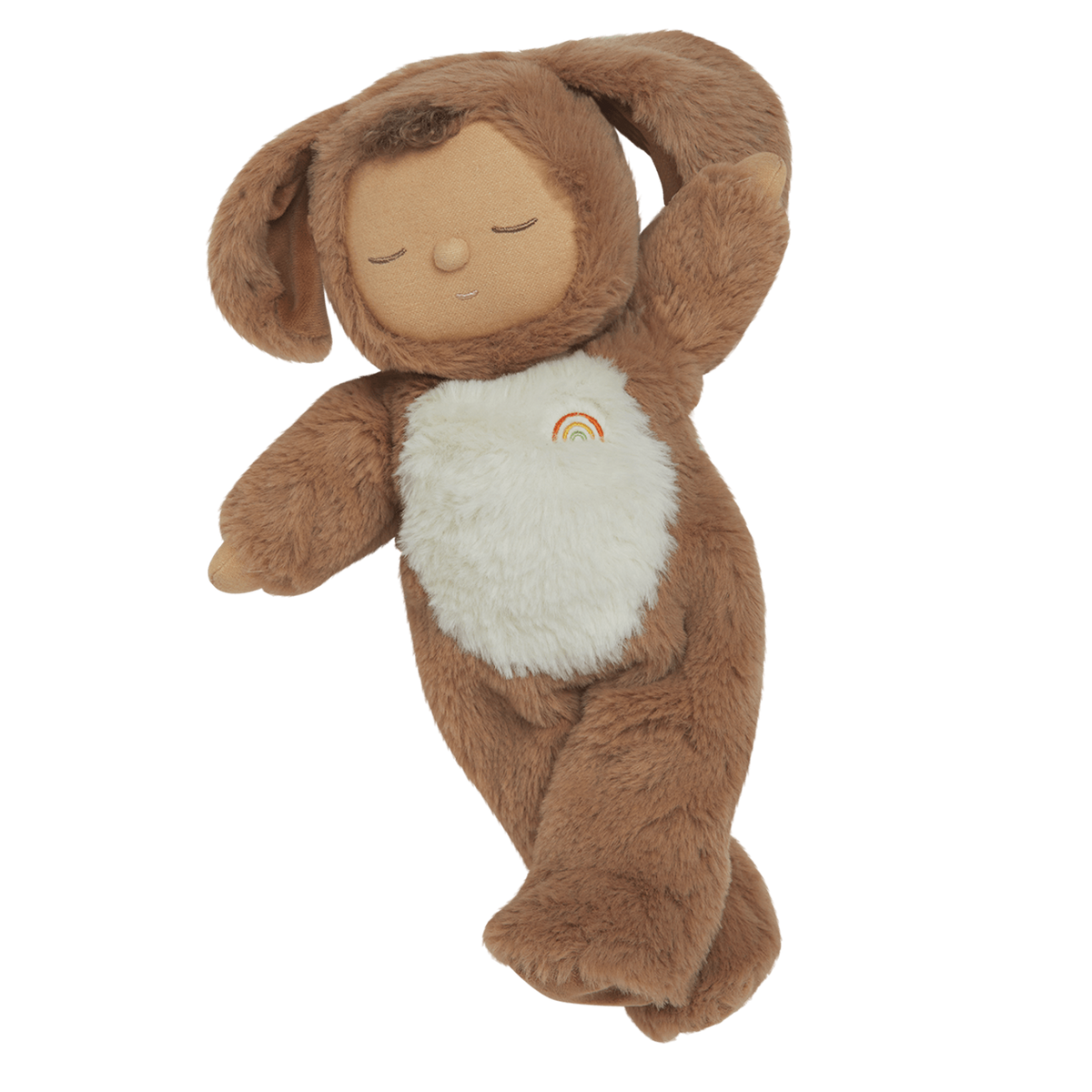 A plush toy with a brown, fluffy dog feature, closed eyes, and a serene expression. It features a white belly with a small embroidered rainbow.