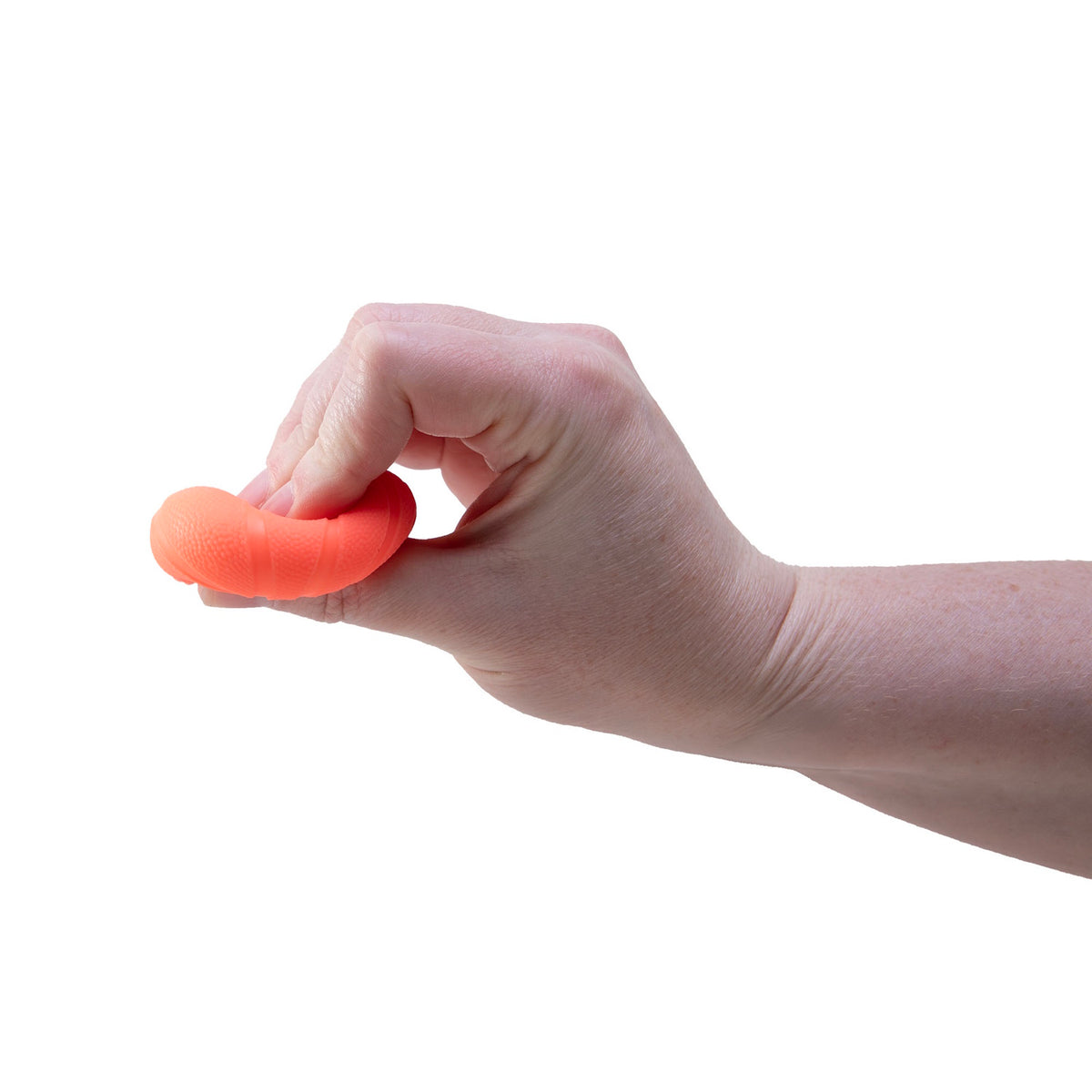 Hand squeezing an orange Teenie NeeDoh squishy fidget toy to demonstrate its flexible, stress-relieving texture.
