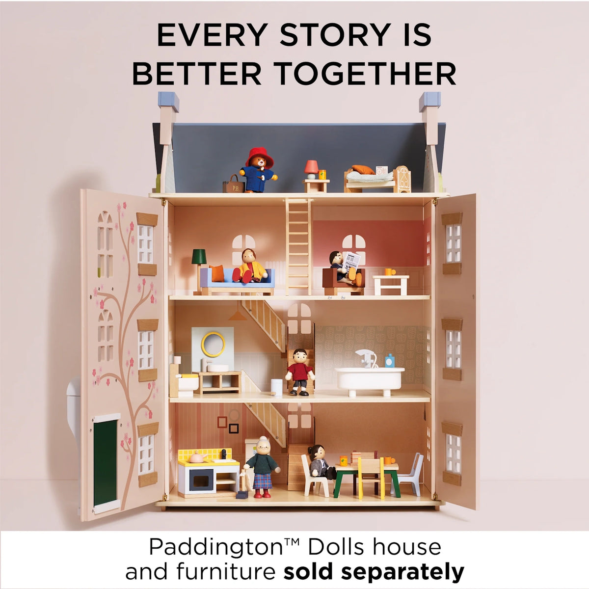 Wooden Paddington Bear figure and family dolls placed throughout the rooms of an open three-story dollhouse.
