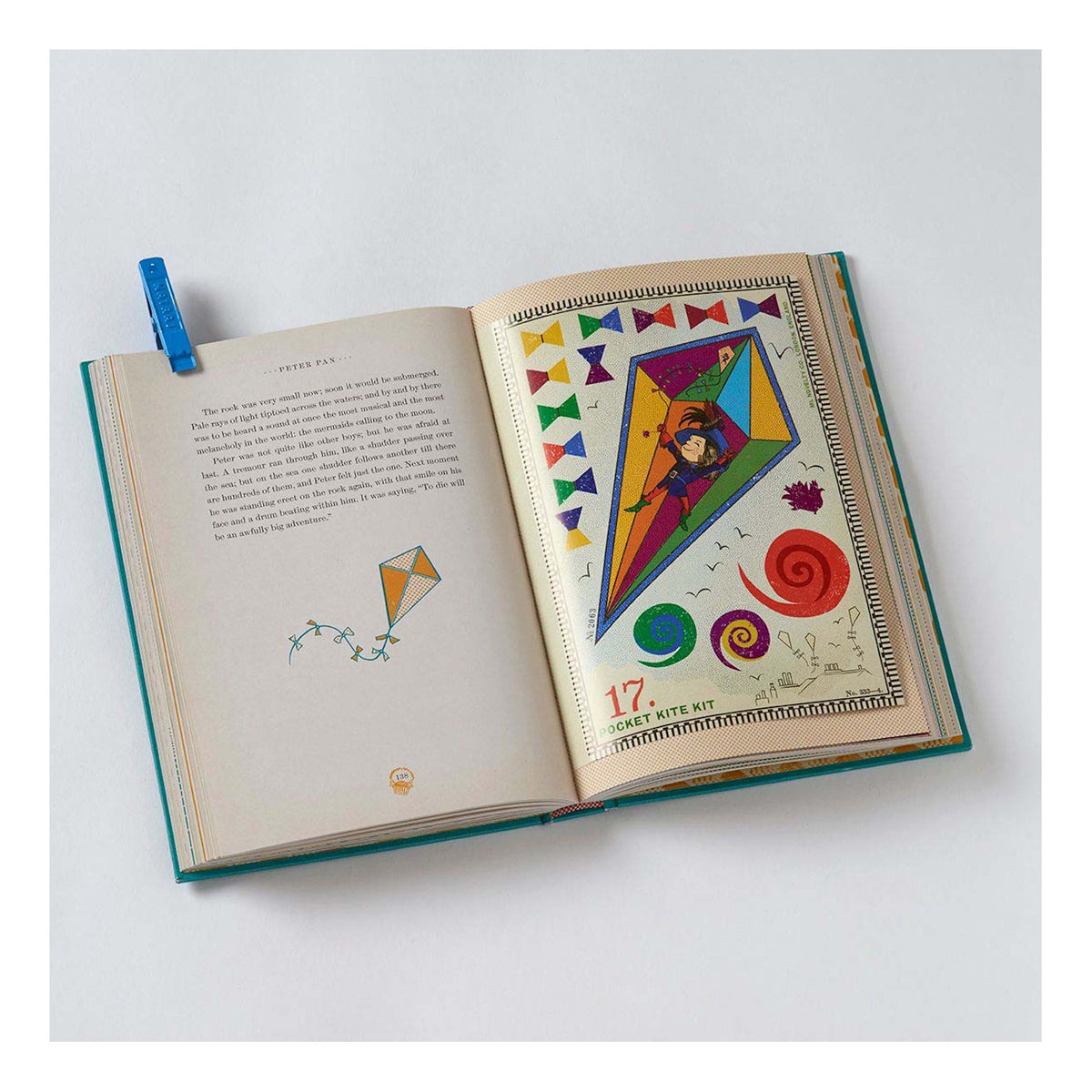 Open Peter Pan book showing a colorful "Pocket Kite Kit" illustration with a boy flying a large kite.