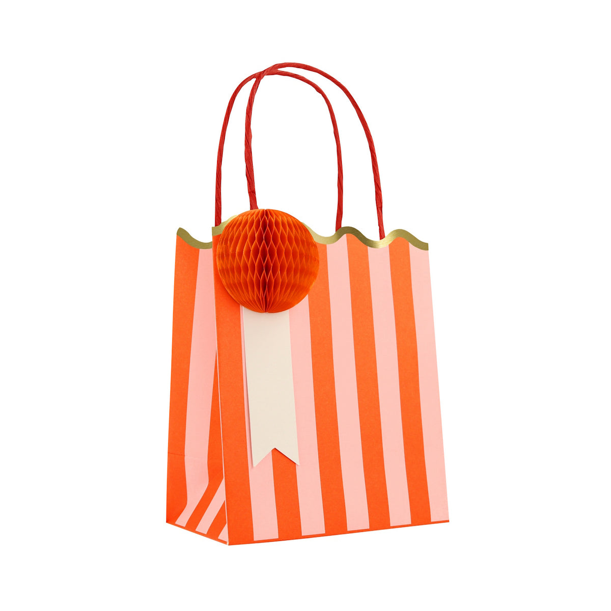 Meri Meri striped party bag with orange and pink stripes, red handles, and an orange honeycomb paper pom-pom.