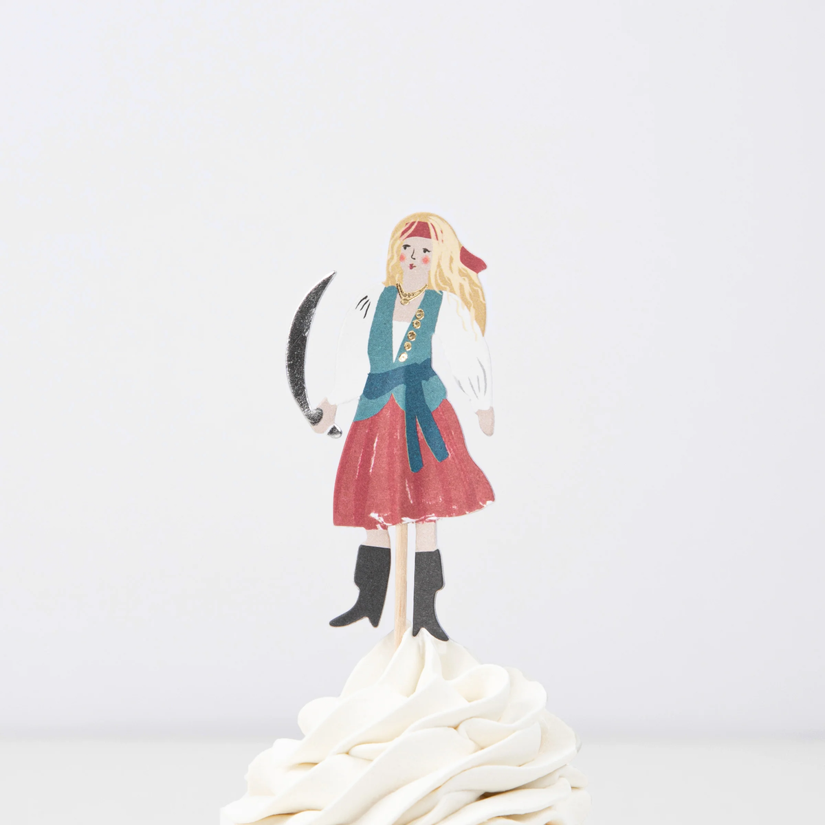 Female pirate cupcake topper holding a cutlass on a wooden pick, placed in swirled white frosting.