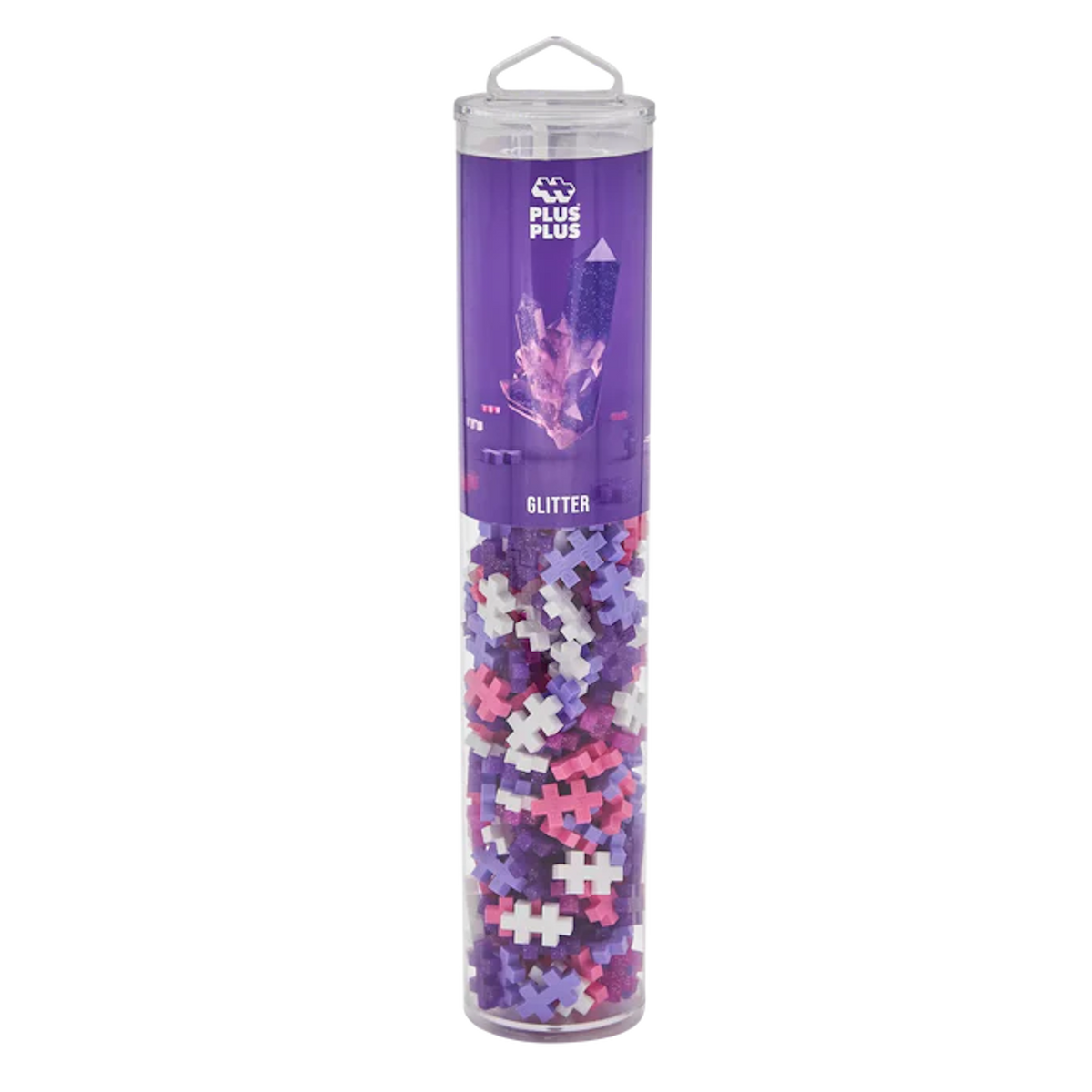 Tall, clear tube with colorful interlocking plastic pieces in purple, pink, and white. The purple label reads "Plus-Plus Glitter" and features crystal graphics.