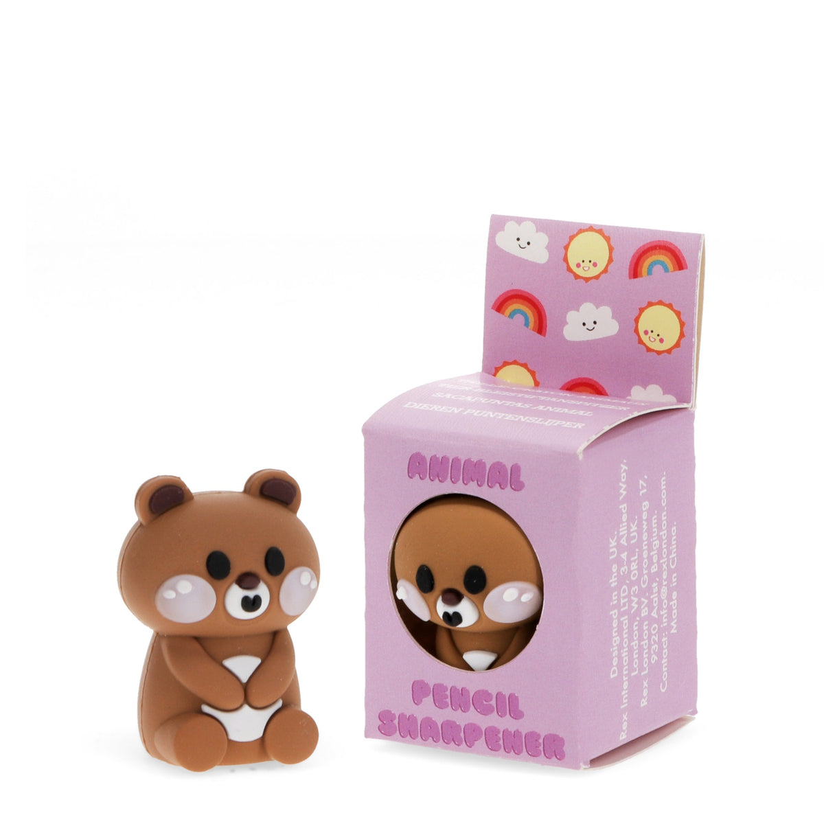 Cute bear-shaped pencil sharpener next to its pink box, which is decorated with smiling suns, clouds, and rainbows. The tone is playful and whimsical.