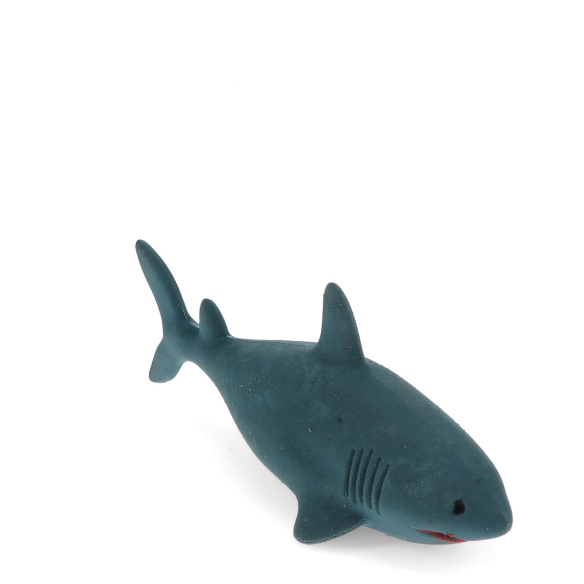 Small eraser shark on a white background. The shark is blue with simplistic features and a hint of a red mouth. It appears playful and non-threatening.