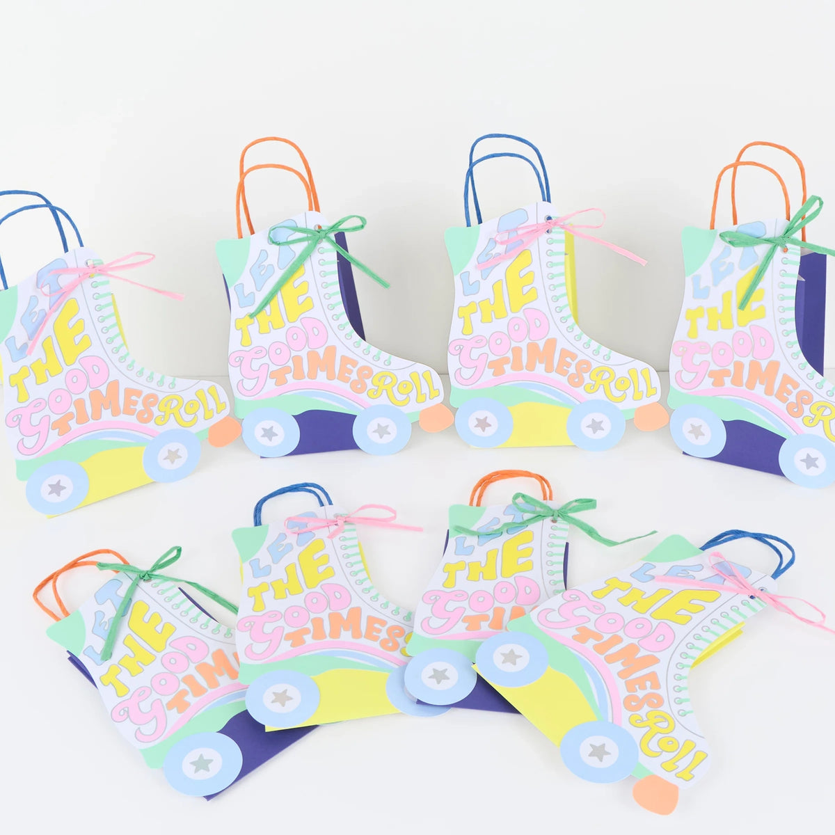 Retro roller skate party favor bags with "Let the Good Times Roll" text in pastel colors for a roller disco theme.