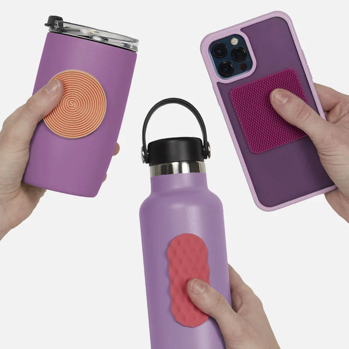 Hands holding purple items with textured silicone sensory stickers attached.